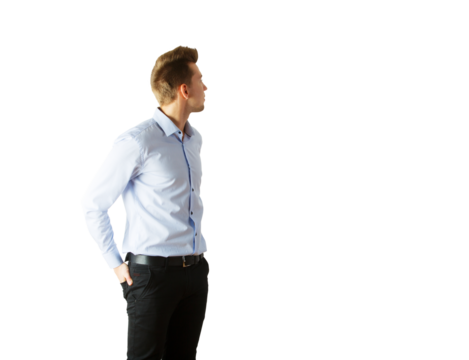 Young man in light blue shirt andpants looking to the side, hands in pockets. Isolated on white background. Concept of casual style