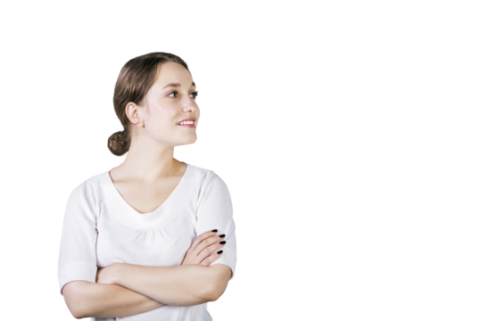 Young woman in white shirt with arms crossed, smiling and looking sideways, isolated on white background. Concept of confidence and positivity