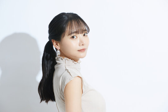光と影の背景で撮影をした若い女性の爽やかなビューティーポートレート