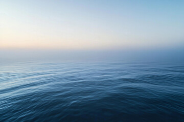 Fototapeta premium Sunset over calm ocean waters creates a serene atmosphere with vibrant colors on the horizon