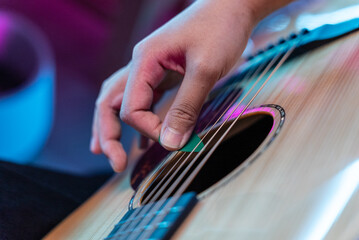 Close up professional women musician composing a song with acoustic guitar, piano keyboard and...