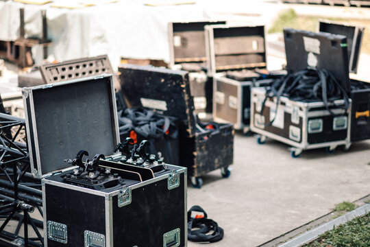 Flight cases with stage lighting equipment are standing on the street