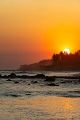 Obraz premium Sunset over Rocky Coastline