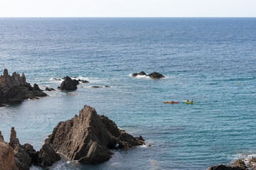 canoes in the ocean passing through the reefs