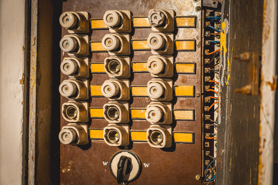 old fuse box. old electrical installation in an electrical cabinet. small and large fuses. electric cables.