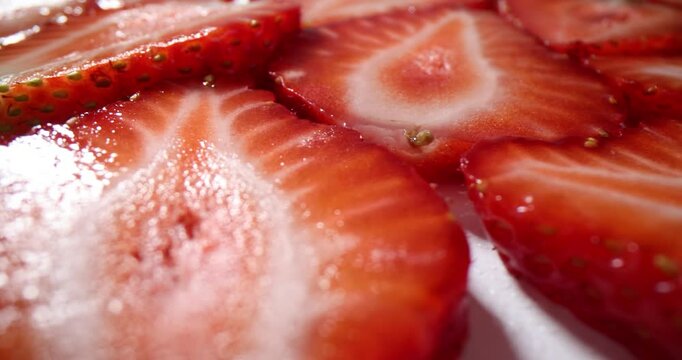 Ripe strawberry sliced halves pattern for dessert on tray. Organic farm berries freshness and vibrant color for healthy vegan diet on summer