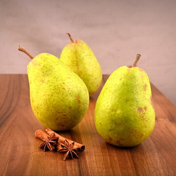 Ripe pear on the table with spices, a harvest of fresh crispy pears.
