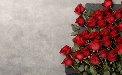 Beautiful red roses frame a luxurious black stone surface, perfect for love letters or advertisements on valentines day.