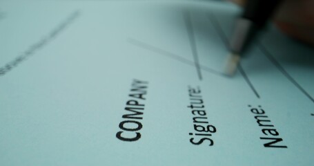 A man puts his signature on behalf of a company representative, close-up of his signature, an unrecognizable person