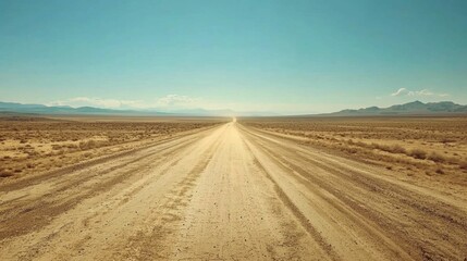 Vast Open Road Unfolds Under Clear Blue Sky in Desert Landscape