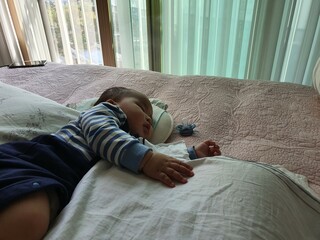 a baby sleeping on bed