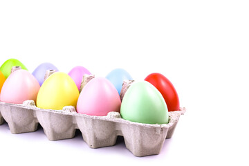 Easter colored eggs in a tray on a white background