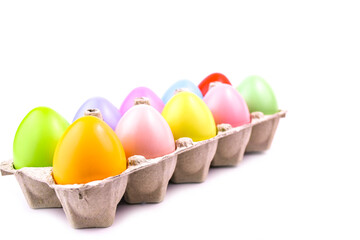 Easter colored eggs in a tray on a white background