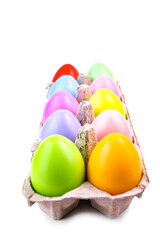 Easter colored eggs in a tray on a white background