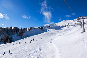 Snowy landscape at Swiss ski resort of Flumserberg with skiers on ski slope on a winter day. Photo taken January 29th, 2025, Flumserberg, Switzerland.