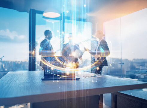 Abstract sci-fi double exposure image of a business meeting.  A futuristic, glowing network surrounds the team, set against a city background.