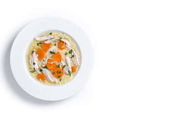 Homemade chicken soup with carrot isolated on white background. Top view. Copy space