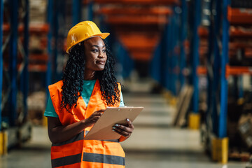Female warehouse worker checking inventory using clipboard in logistics center