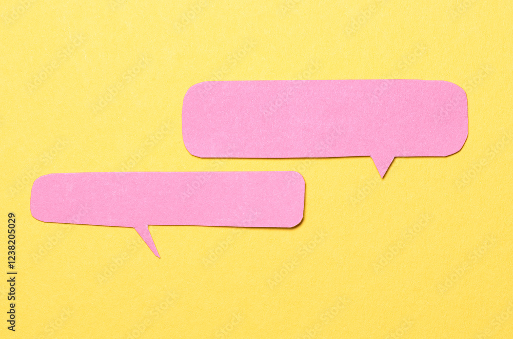 Poster pink blank cut out paper speech bubbles with copy space for text on yellow background, flat lay top 