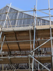 Large Industrial Building Covered and Surrounded with Scaffolding