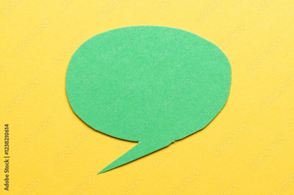 Poster green cut out blank paper speech bubble of round shape with copy space for text on yellow background