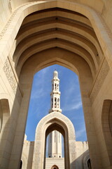 Fototapeta premium The Sultan Qaboos Grand Mosque in Muscat, Oman, with arches and the minaret
