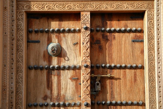 A typical wooden door with carvings in the neighborhood Al Akr in Nizwa, Al Dakhiliyah, Oman