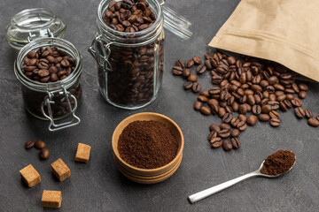 Ground coffee in wooden bowl and spoon.