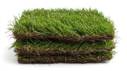 A stack of artificial grass mats for landscaping and recreational use.