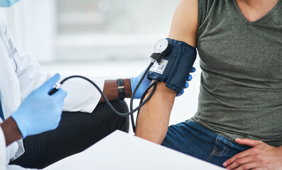 Doctor, blood pressure and checkup for patient, hands and communication for hypertension and healthcare. Hospital, people and medical professional with sphygmomanometer, health or consulting for test