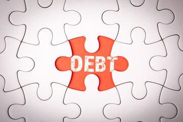 Fototapeta premium Debt. White puzzle pieces on an red background