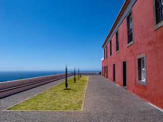 Beautiful ensemble with a red house, below the Casa das Mudas museum, in the small town of Calheta.