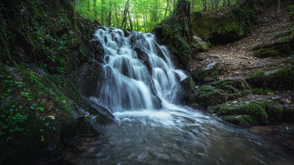 Romantic German River in Summer with Rocks Waterfall and Sunlight