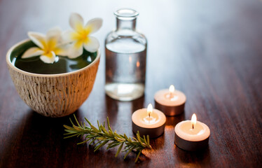 Flowers, candles and bowl of water in spa for self care, wellness and beauty treatment. Salon aesthetic, holistic and rosemary herbs for cosmetics, aromatherapy and health for zen, calm and peace