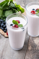 Fresh raspberry and blueberry smoothie on wooden table