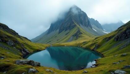A rugged mountain range with a lake at its base, covered in fog and moss, landscape, nature