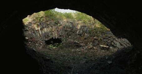 Three friends run into the basement of a destroyed building. The view from the inside