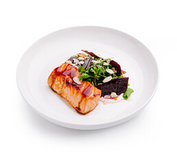 Deliciously plated salmon with greens and beets presented elegantly on a white dish