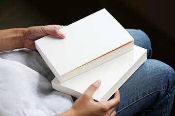 Woman sitting on a chair with a book in her hand