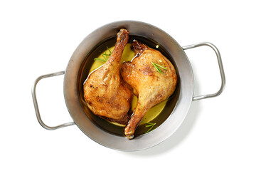 Freshly roasted duck legs confit in oven pan isolated on white background, top view	