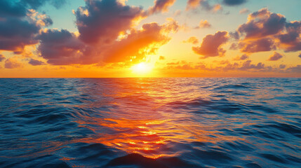 Obraz premium A vibrant sunset over the ocean, casting colorful reflections on the water's surface.
