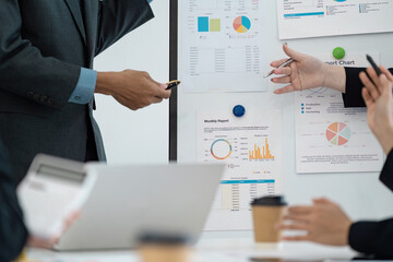Business professionals analyzing monthly reports during a strategic meeting.