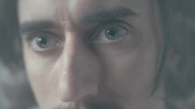 surprise in the eyes Close-Up of Surprised Man Detailed shot of a kind and confident man with a mustache and long hair showcasing big expressive eyes filled with surprise