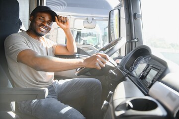 Young handsome African American man working in towing service and driving his truck