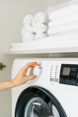 Efficient washing machine in a modern laundry room with organized towels