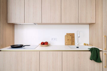 Minimalist kitchen design featuring modern induction hob and wooden accents