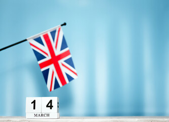 March calendar with British flag with number  14. Calendar cubes with numbers. Space copy.