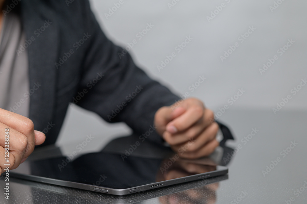 Poster professional person using tablet computer in modern office setting