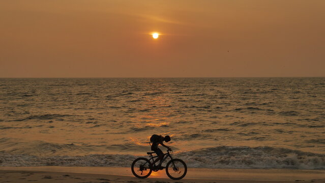 bike on the beach at sunset
