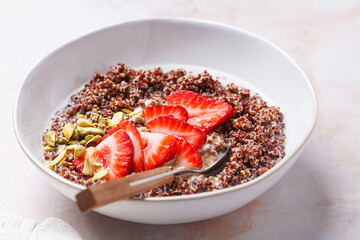 Breakfast quinoa bowl with strawberries and pistachio.